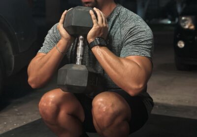 Man performing squats with Flexelent squat wedges