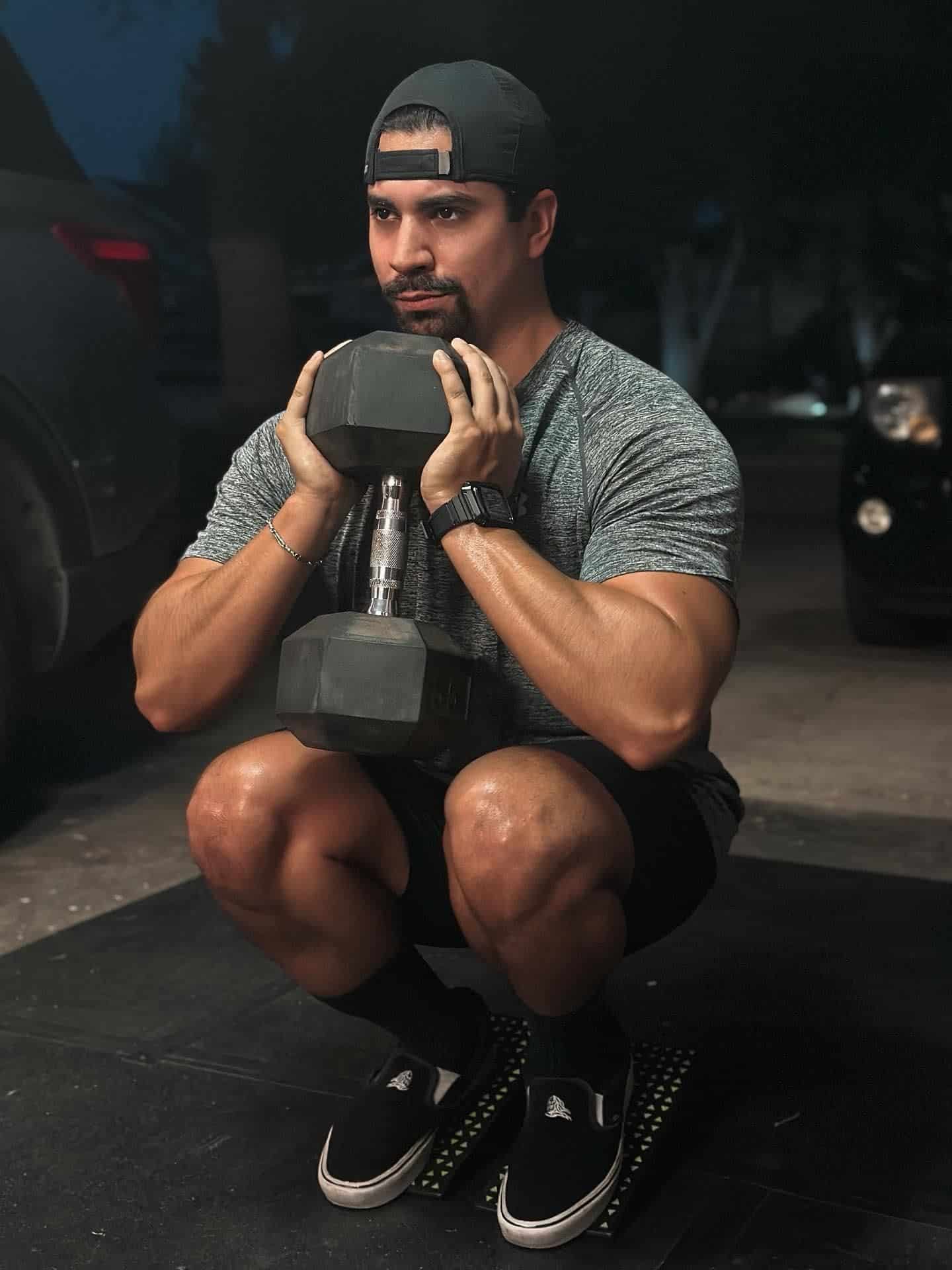 Man performing squats with Flexelent squat wedges