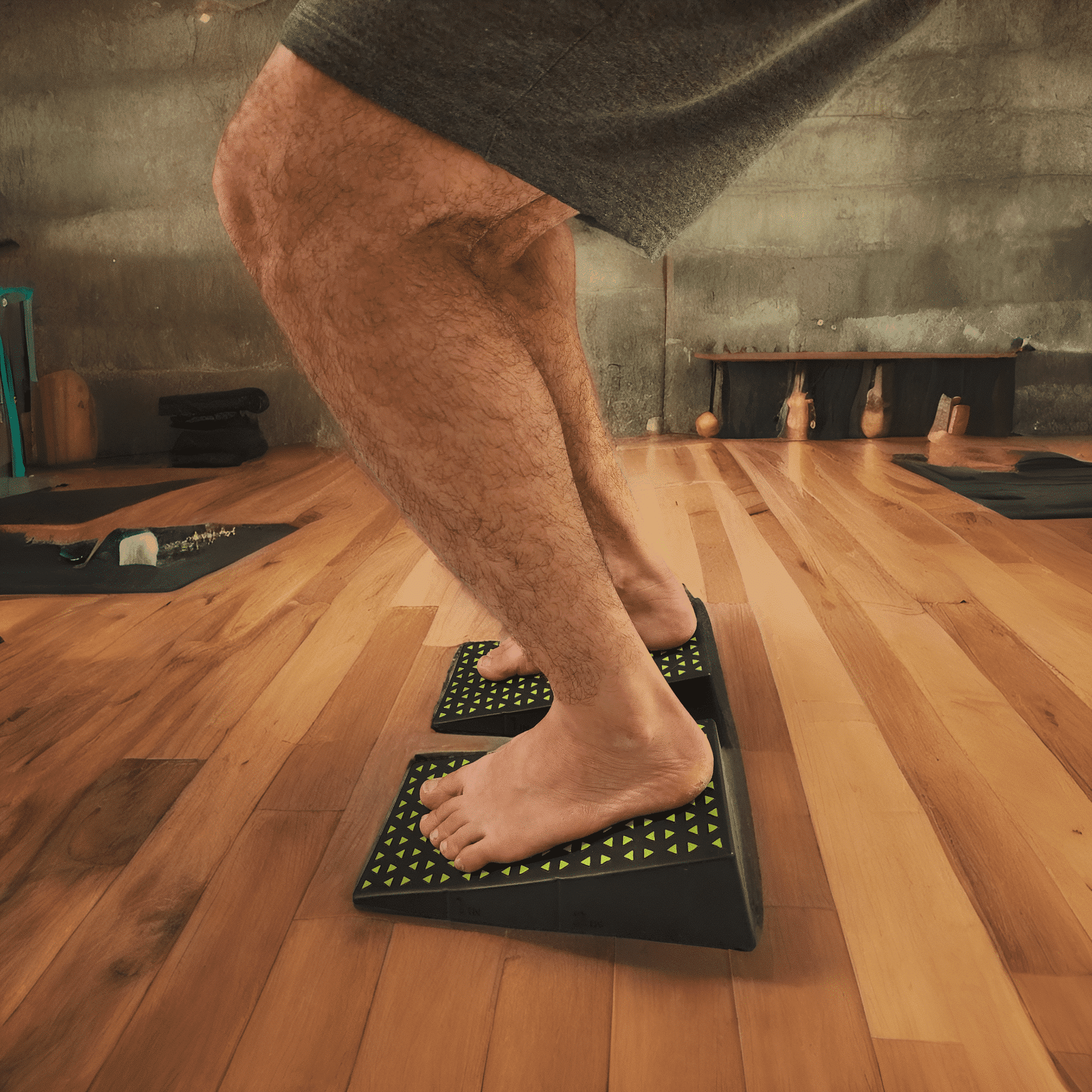 Close-up of barefoot yoga squat using Flexelent squat wedges