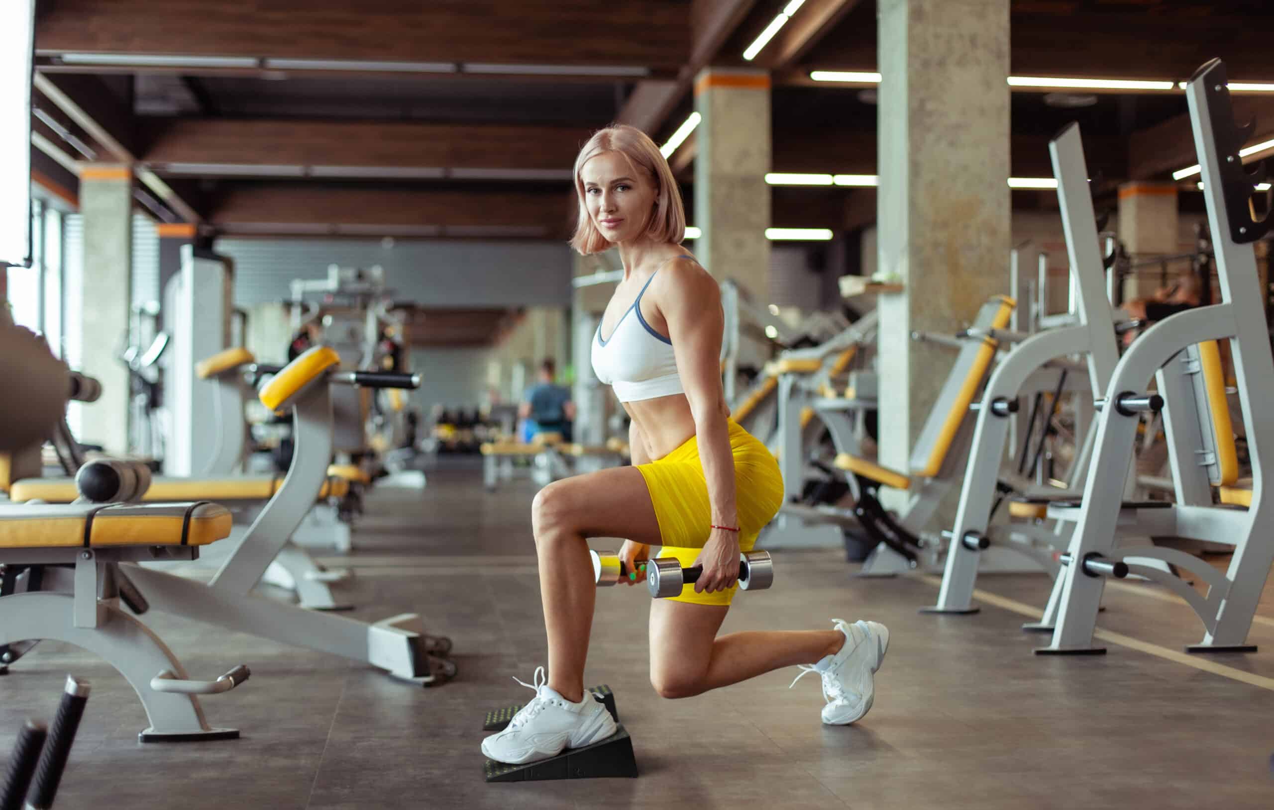 Woman performing lunges with squat wedges for optimal body alignment and performance